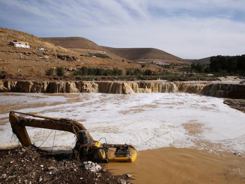 An excavator is partially submerged in a stream after rain storms unleashed flash floods, in Madaba city, near Amman, Jordan, November 10, 2018. PHOTO: REUTERS