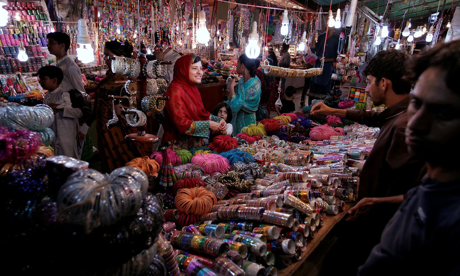 A woman buy bangles and jewellery at a stall ahead of Eid al-Fitr in Islamabad. PHOTO: REUTERS