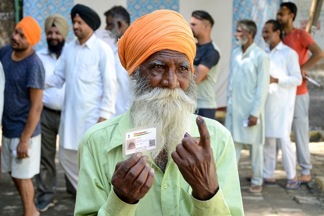 Indian voter Ajeet Singh shows his ink-marked finger after casting his vote during the 7th and final phase of India's general election at a polling station in a village on the outskirts of Amritsar on May 19, 2019. PHOTO: AFP