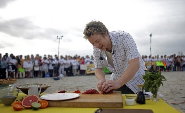 The Naked Chef Jamie Oliver slices fish during an appearance on NBC's "Today" show in Miami Beach, Florida February 22, 2008. PHOTO: REUTERS/FILE