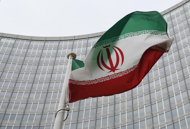 An Iranian flag flutters in front of the International Atomic Energy Agency (IAEA) headquarters in Vienna, Austria. PHOTO: REUTERS