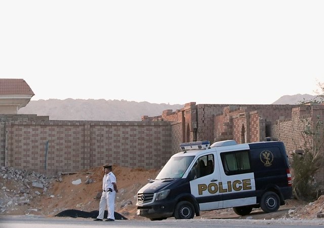 Policemen guard outside the cemetary where the lawyers of ousted Egyptian Islamist President Mohamed Mursi say he was buried, early morning in Cairo, Egypt. PHOTO: REUTERS