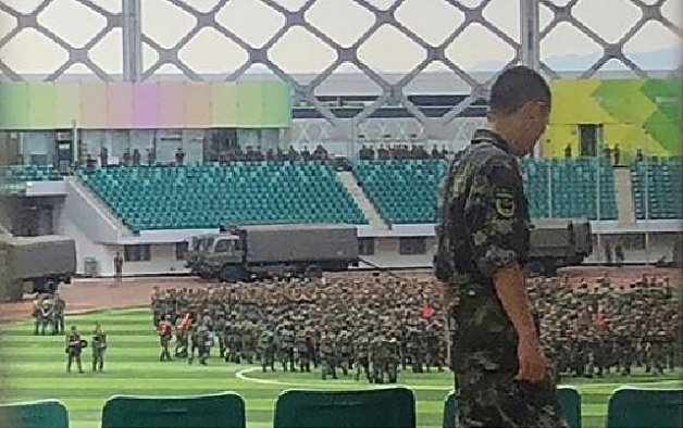 Military personnel parade inside the stadium. PHOTO: AFP