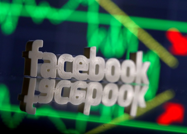 A 3D-printed Facebook logo is seen in front of displayed stock graph in this illustration photo, March 20, 2018. PHOTO:REUTERS