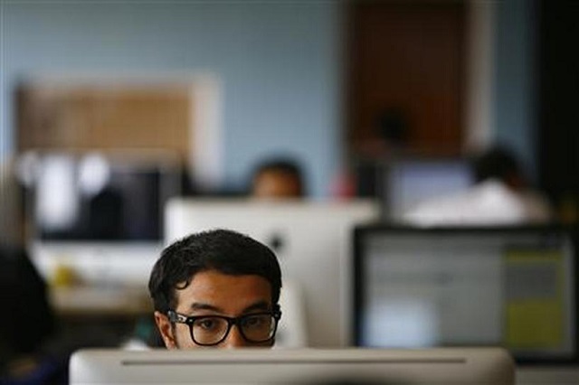 An employee works on his computer at the office of CloudFactory, a Canadian startup that based itself in Kathmandu, where it hires teams of Nepalese October 5, 2012. REUTERS/FILE