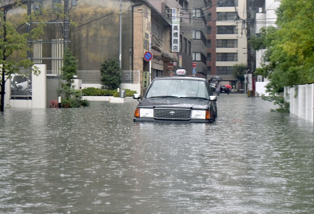 A taxi is stuck in floodwaters caused by heavy rain, in Saga, southern Japan. PHOTO: Reuters