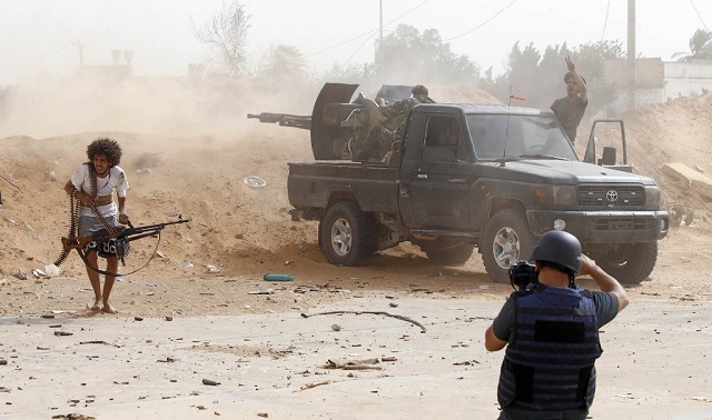 A journalist covers the frontline during clashes between forces loyal to strongman Khalifa Haftar and fighters loyal to the Libyan internationally-recognized Government of National Accord (GNA), south of the Libyan capital Tripoli. (Photo: AFP)