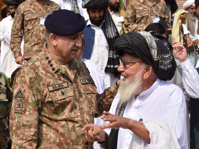 General Qamar interacts with a tribal elder during his visit to Miranshah on Friday. PHOTO: ISPR