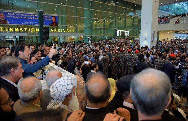Prime Minister Imran Khan addresses supporters at Islamabad airport.
