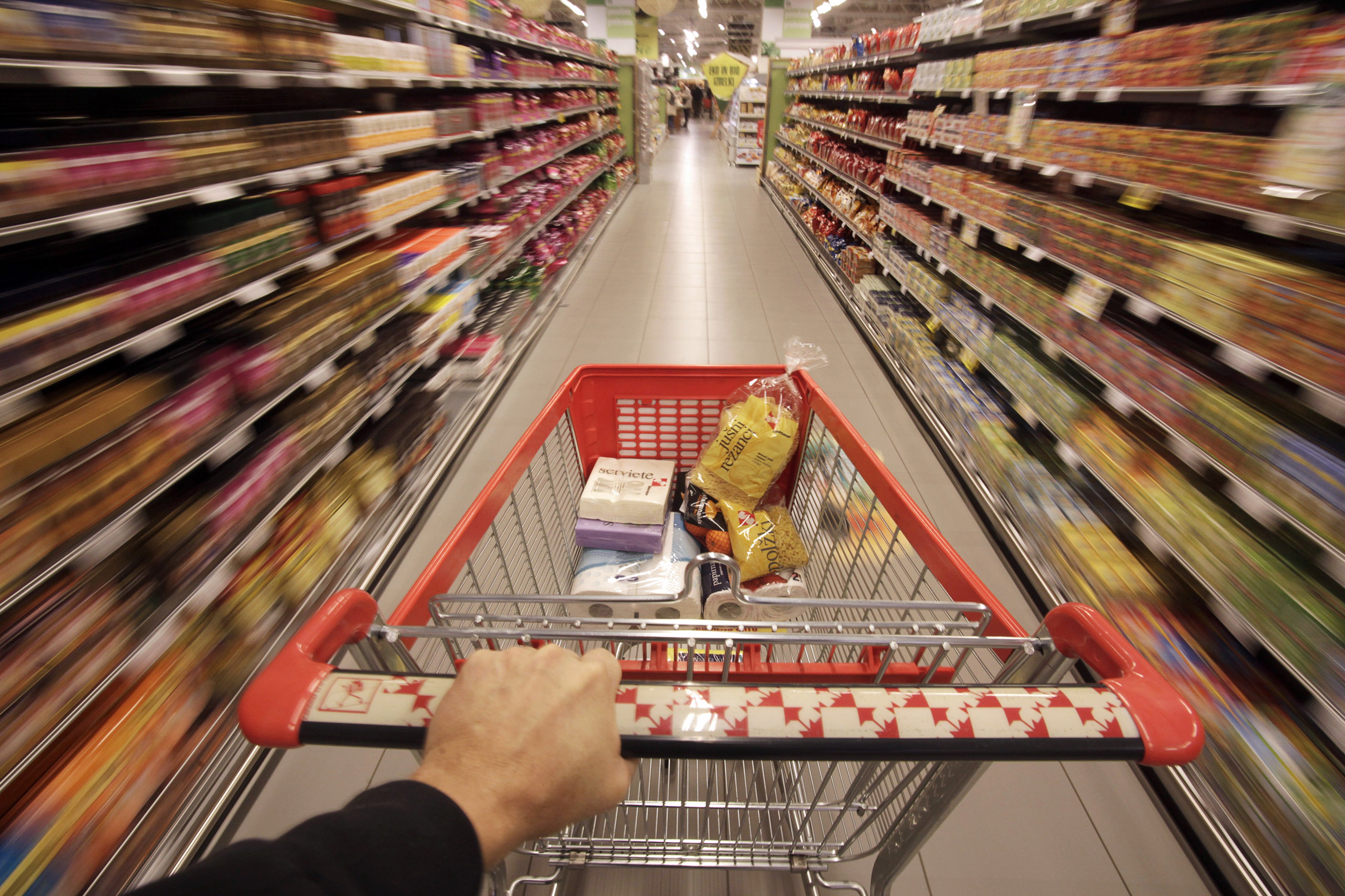 A shopping cart is pushed down the aisle in this REUTERS photo illustration.