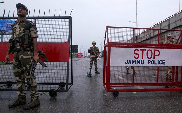 Security personnel stand guard at a roadblock in Jammu on August 7, 2019. PHOTO: AFP