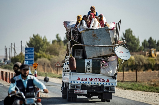 Civilians fled their homes in vehicles or on foot with their belongings. PHOTO: AFP