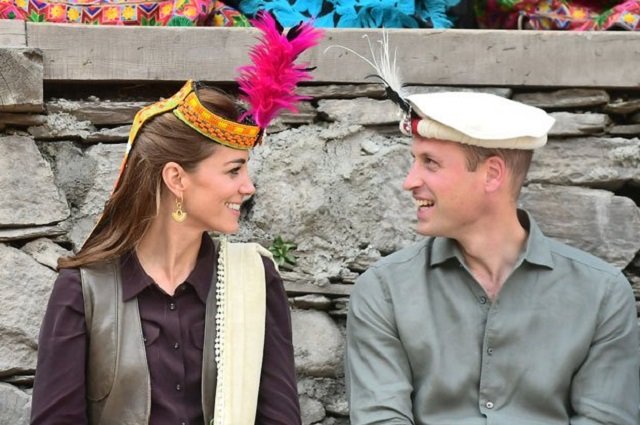Britain's Prince William and Kate Middleton, Duchess of Cambridge, look at each other while visiting a settlement of the Kalash people in Chitral, Pakistan. PHOTO: REUTERS