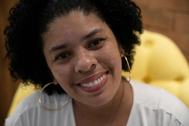 Ana Claudia, 37, smiles as she poses for pictures during an interview. PHOTO: AFP