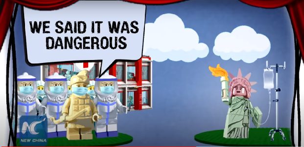In the animation, red curtains open to reveal a stage featuring Lego-like figures in the form of a terracotta warrior wearing a face mask and the Statue of Liberty. SCREENGRAB
