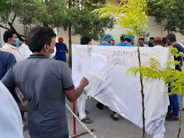 A man looks at a list of the deceased and injured brought in to JPMC from the crash site, posted at an information desk outside the hospital. Many of the bodies remain unidentified. PHOTO: EXPRESS