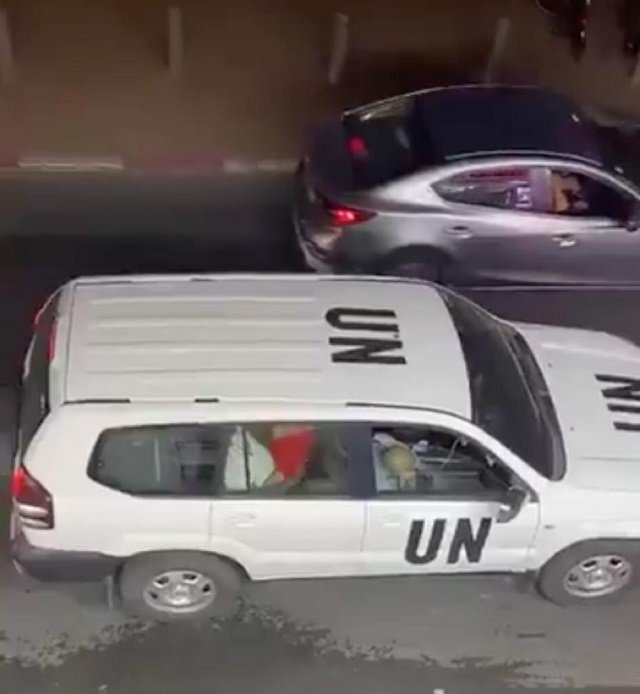 Clip shows a woman in a red dress straddling a man in the back seat of a jeep with UN markings in Israel.SCREENGRAB: TWITTER
