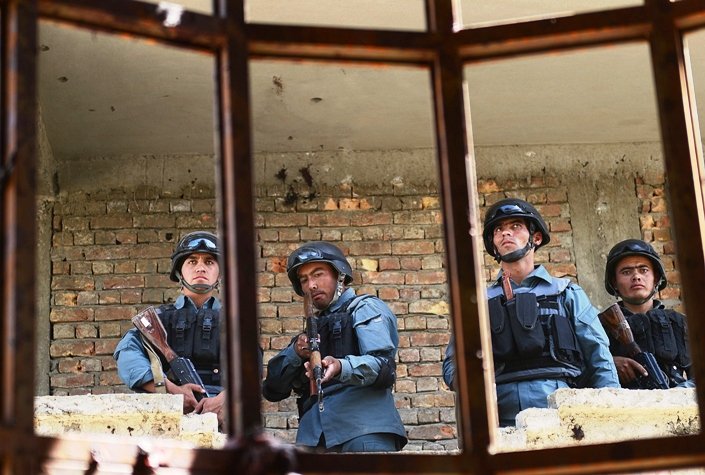 Afghanistan policemen stand guard in a building which was used for an attack. PHOTO: AFP/FILE
