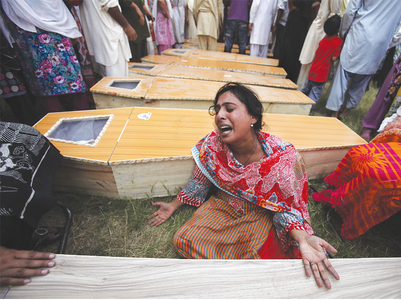 A woman mourns next to the casket of her brother, who was killed in the twin suicide attacks.
PHOTO: REUTERS