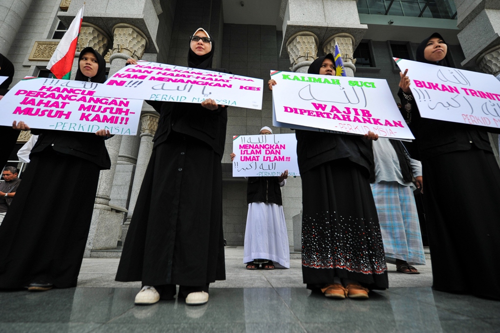 Protesters display placards during a demonstration at the court of appeal in Putrajaya. PHOTO: AFP