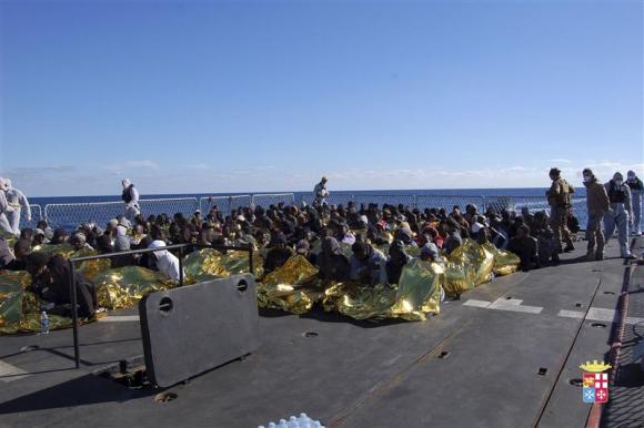 Migrants sit in a Marina Militare vessel during a rescue operation by Italian navy off the coast of the south of the Italian island of Sicily. PHOTO: REUTERS