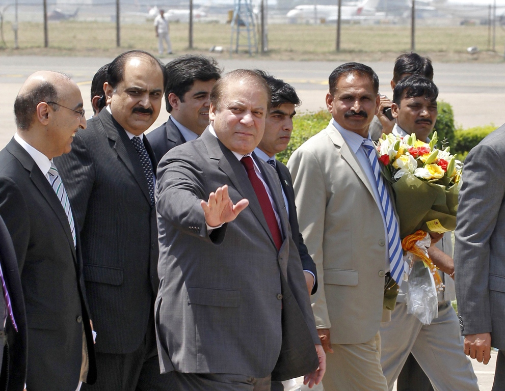Prime Minister Nawaz Sharif waves upon his arrival at the airport in New Delhi May 26, 2014. PHOTO: REUTERS