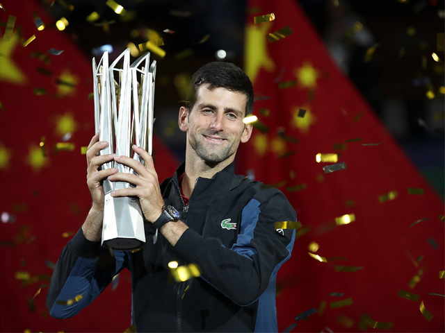 Novak Djokovic of Serbia poses with trophy after winning his men's singles final match against Borna Coric of Croatia on day 8 of Shanghai Rolex Masters on October 14, 2018 in China. PHOTO: GETTY