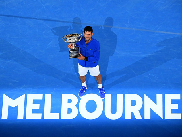 Novak Djokovic of Serbia poses with the Norman Brookes Challenge Cup following victory in his Men's Singles Final match against Rafael Nadal of Spain during day 14 of the 2019 Australian Open on January 27, 2019 in Melbourne, Australia. PHOTO: GETTY