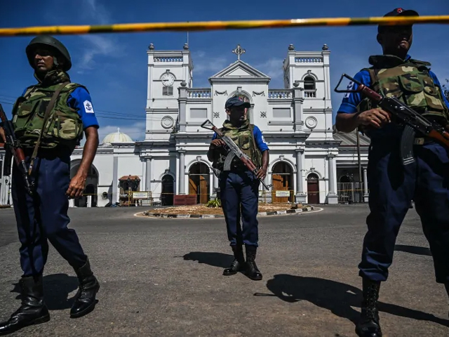 Security personnel stand guard outside St. Anthony's Shrine in Colombo on Monday, a day after the church was hit in series of bomb blasts targeting churches and luxury hotels in Sri Lanka. PHOTO: AFP