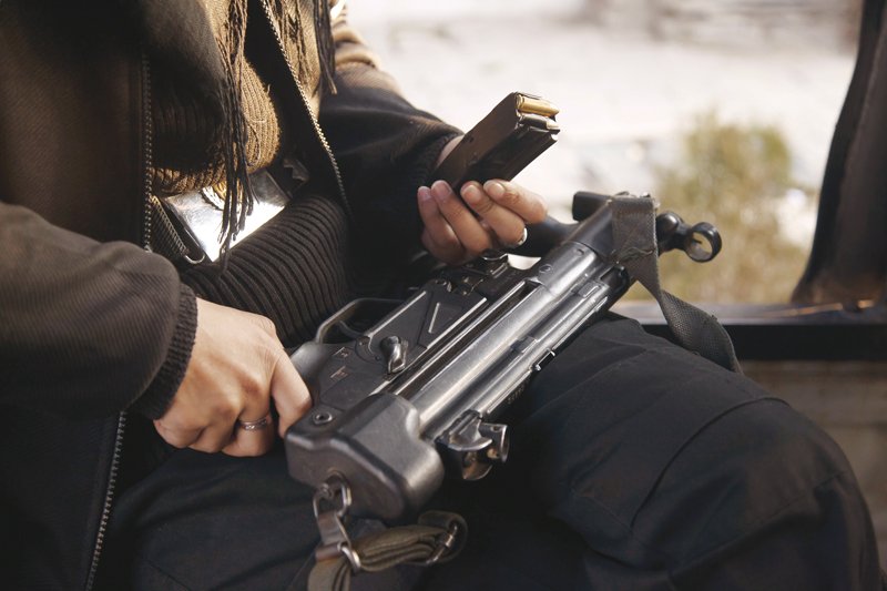 A female commando with an MP5 on the unit patrol vehicle. PHOTO: SA’ADIA KHAN