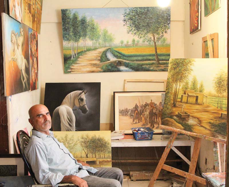 Cinema Artist Yousuf Shah finds his true calling in painting backdrops for theatres and portraits of characters. PHOTO: AYSHA SALEEM/EXPRESS