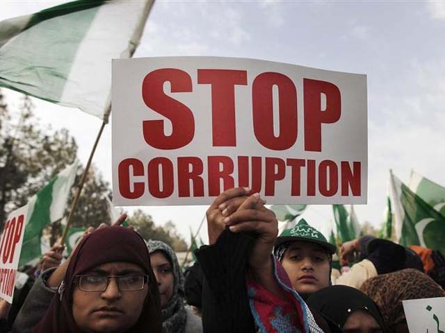 Protesters hold a sign as they take part in a protest in Islamabad. PHOTO: REUTERS