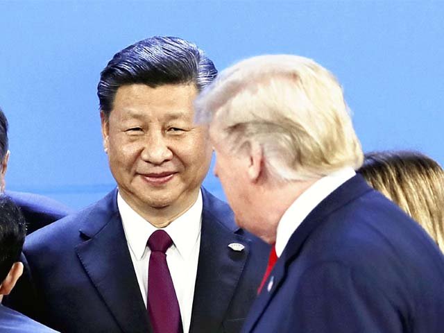 Donald Trump and Xi Jinping attend the G20 summit conference. PHOTO: AFP