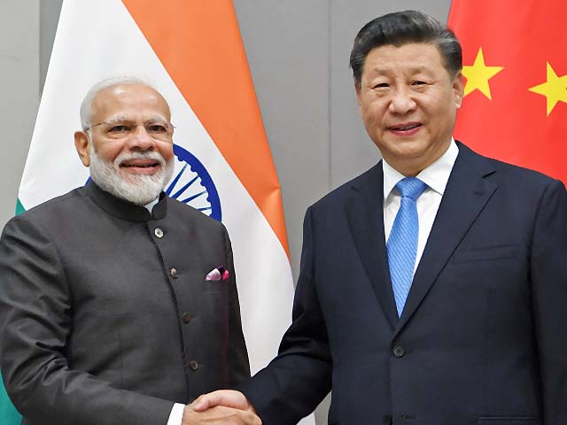 Xi Jinping meets with Narendra Modi in Brazil. PHOTO: AFP